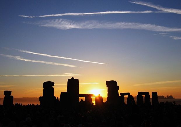 A photo of the sun setting over Stone Henge